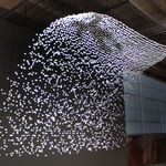 Still image of an installation view with a view from behind the piece