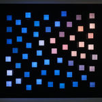 An image of little random square pegs in a black panel of exploded random colors