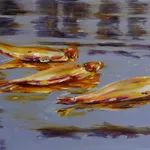 Three dead herrings floating on reflective water surface.