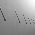 Still image of several multi-colored LEDs sticking out from a white wall on angled metal rods The LEDs in the image are turned off