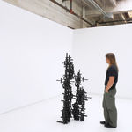 Installation view of Totem with a white man admiring it