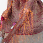 A detailed shot of the doll's long arms and dress.