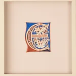 A decorative medieval illuminated manuscript letter “E” in red, blue, and cream, featuring intricate floral and vine-like patterns inside the letterform, centered on a plain parchment background within a wide margin. From an Atlantic Bible, Tuscany, Italy, 12th century.