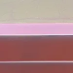 abstract work made of horizontally aligned segments in desaturated tones of red, pink, and green