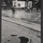 A street in Hanoi, with a closeup in the foreground of the omnipresent manhole shelters, which civilians can dive into in the event of an air attack.