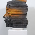 "Mind Bending" a sculpture of a face made from wooden sticks and paint by slate gray gallery artist Gil Bruvel