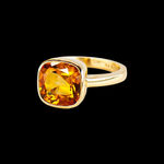 Gold ring with faceted orange stone