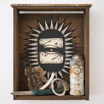 Wooden shelf with painting of an eye by GATS with several trinkets in the shelf including a spray can, handcuffs, piece of wood and a knife
