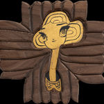 A piece of carved wood with a portrait in an illustrative style in gold leaf.