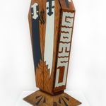 Wooden coffin with two ghost painted on the front doors and GATS written on the side