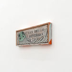 GATS character painted on a white wooden sign with black lettering