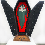 Open coffin with black doors and painted vampire on red background on inside