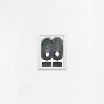 Ted Collier work on paper with two figures and chaotic vicious circle heads in charcoal on white background framed in a white frame hanging on a white wall