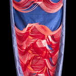 Blue and red fabric sculpture hung on wall