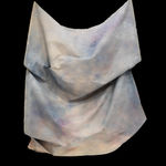 multicolored draped fabric sculpture on wall