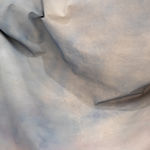 detail shot of draped fabric sculpture on wall