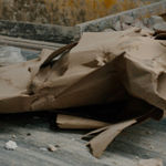 Karyn Olivier's Drift (Tributary), a video still of recyclables and debris on a conveyer belt