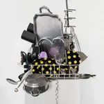 Sculpture with various china, ceramic, kitchen utensils and modified dishwasher on pedestal