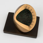 small bronze sculpture with a green inside