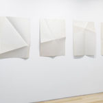 Series of white folded paper pieces