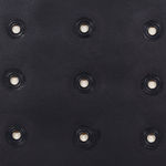 Detail of a piece of thick black paper with organic rough edges is penetrated by a neat array of fifteen grommets