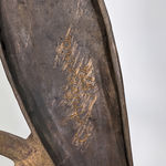 Detail of Modernist bronze sculpture of a stylized owl with large eyes perched on a circular base