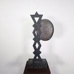 Modernist bronze sculpture of a stylized profile with a braided hairdo reminiscent of folklore motifs, on bronze base