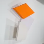 Detail of Tridimensional painting of interconnected parallelograms in orange, white, and beige