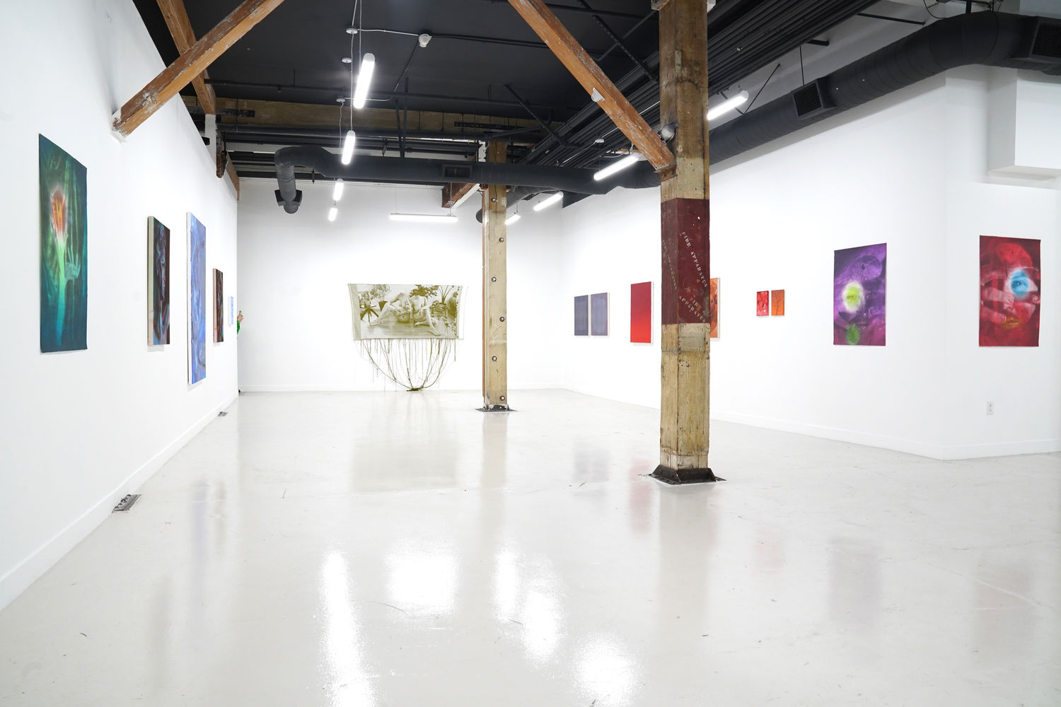 photo of the gallery layout with a monochromatic themed art exhibition installed