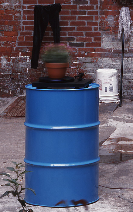 Installation view of Roman Signer, Flower Pot, 2008, oil drum, record player, flower pot (kalancoe), 33 1/3 RPM, 48 x 24 x 24 in. Flower Pot, 2008, James Fuentes LLC, 35 St. James Place. Courtesy of James Fuentes Gallery.