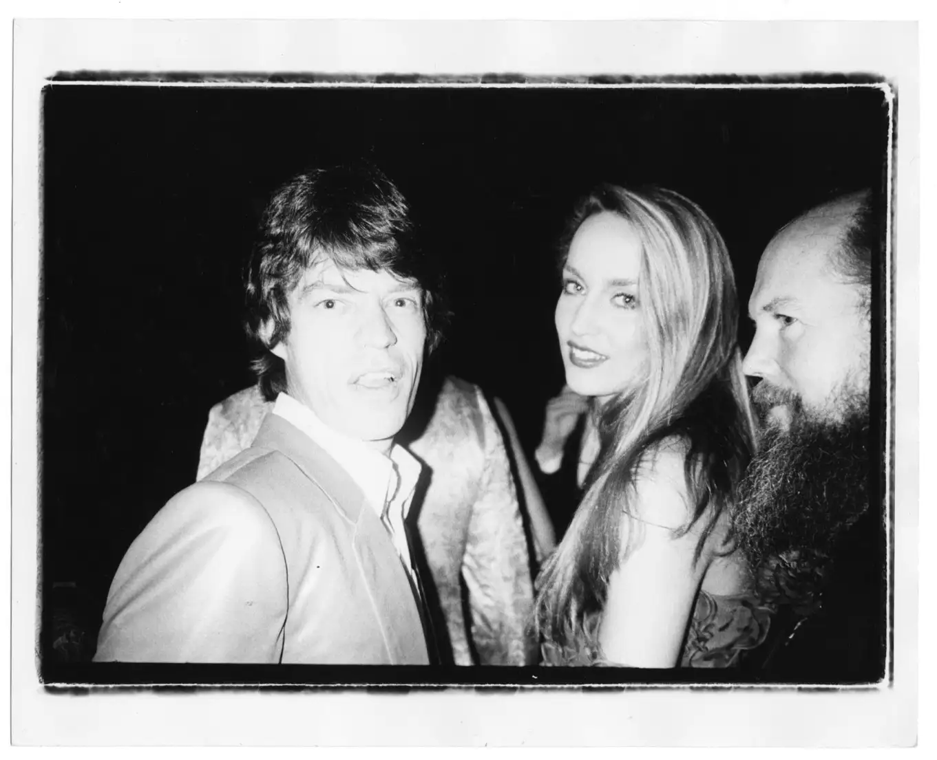 Bob Colacello, 'Mick Jagger, Jerry Hall, and Garech Browne, Red Ball, Paris', 1980, Vintage gelatin silver print, Image 20,3 x 25,4 cm (8 x 10 in), Frame 24,3 x 29,2 cm (9 1/2 x 111/2 in). © Bob Colacello. Courtesy Thaddaeus Ropac