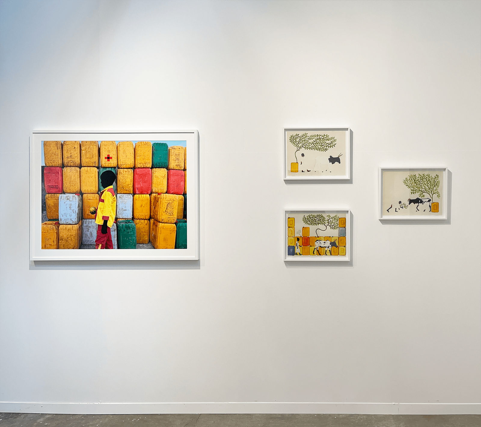 Installation view of AFIKARIS booth at Art Brussels showing Saïdou Dicko's painted photograph and drawings