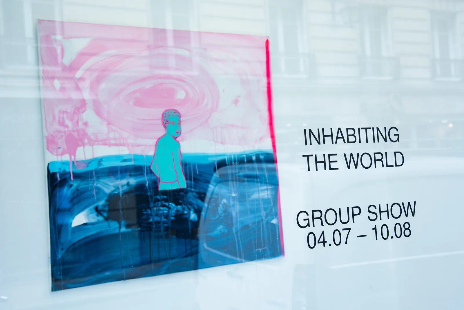 View of AFIKARIS gallery's window featuring Les égarés by Omar Mahfoudi. A work on canvas showing a blue man amidst a water landscape