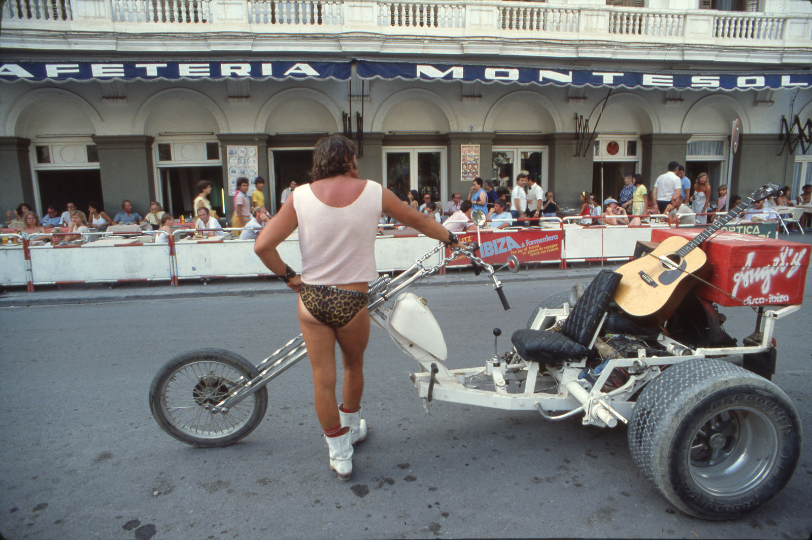 Oriol Maspons, Elvis "The Naked Cowboy" and his Chopper Trike outside the Montesol Hotel, Ibiza, Spain, cerca 1982