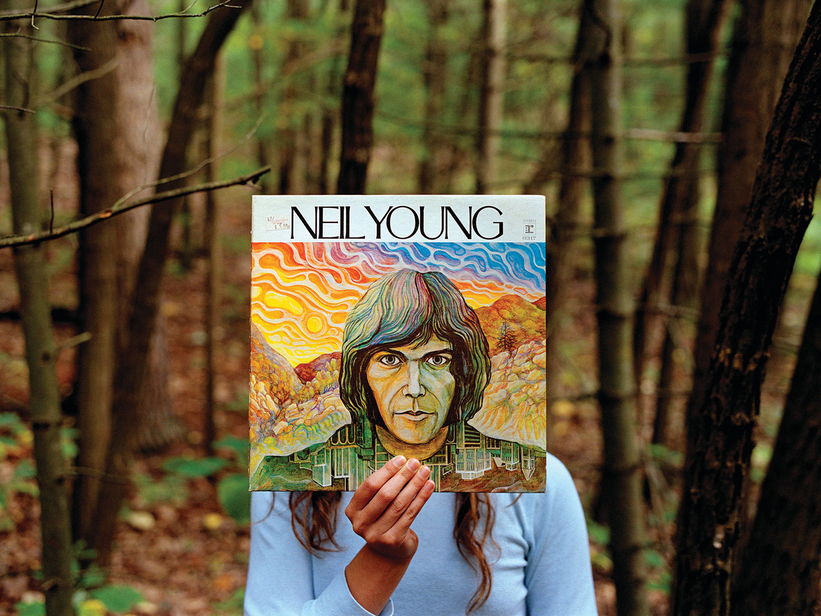 Melanie Schiff photograph featuring person holding Neil Young vinyl album in forest