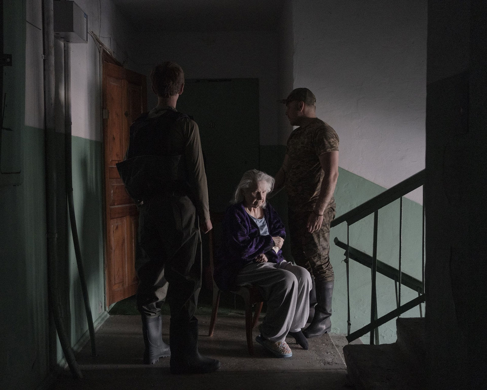 Johanna-Maria Fritz, Viktor and Yevhen carry Maria from her 9th-floor apartment for evacuation, 2023