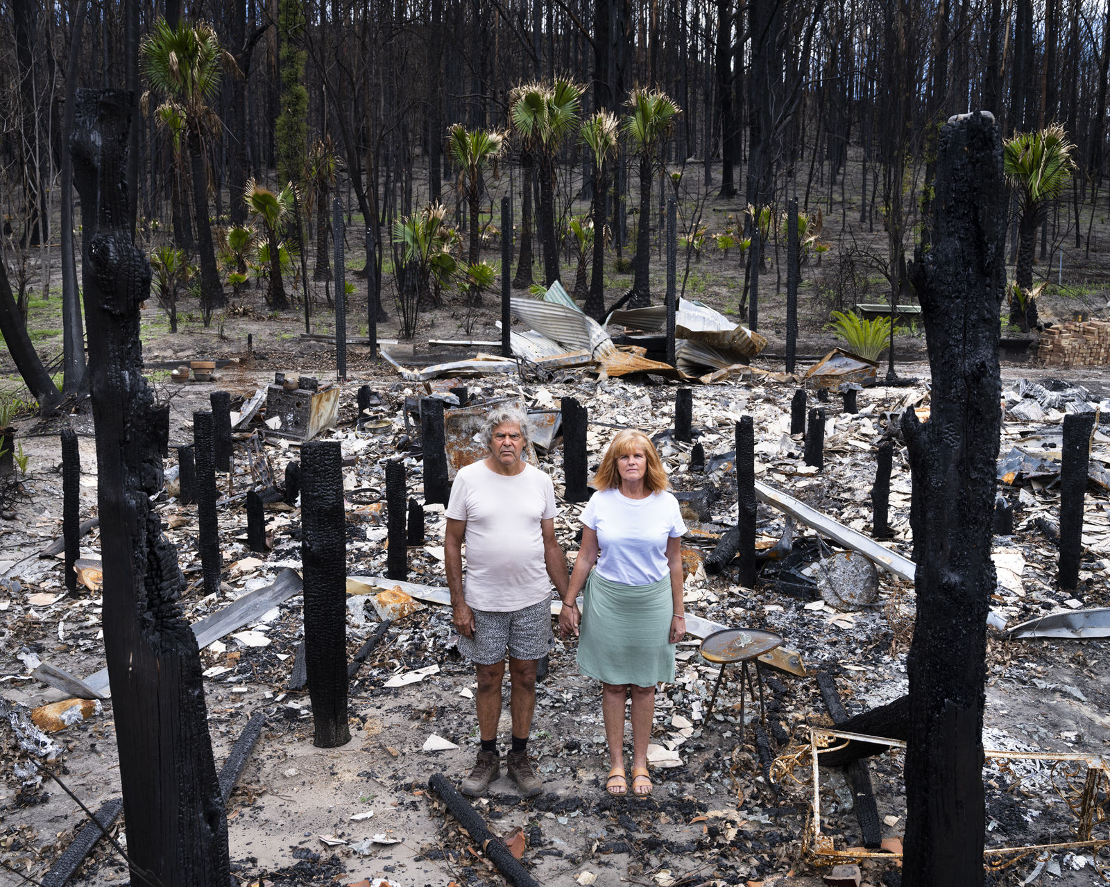 Gideon Mendel, Noel and Trish Butler at their burnt home in Nuragunyu, New South Wales, 2020