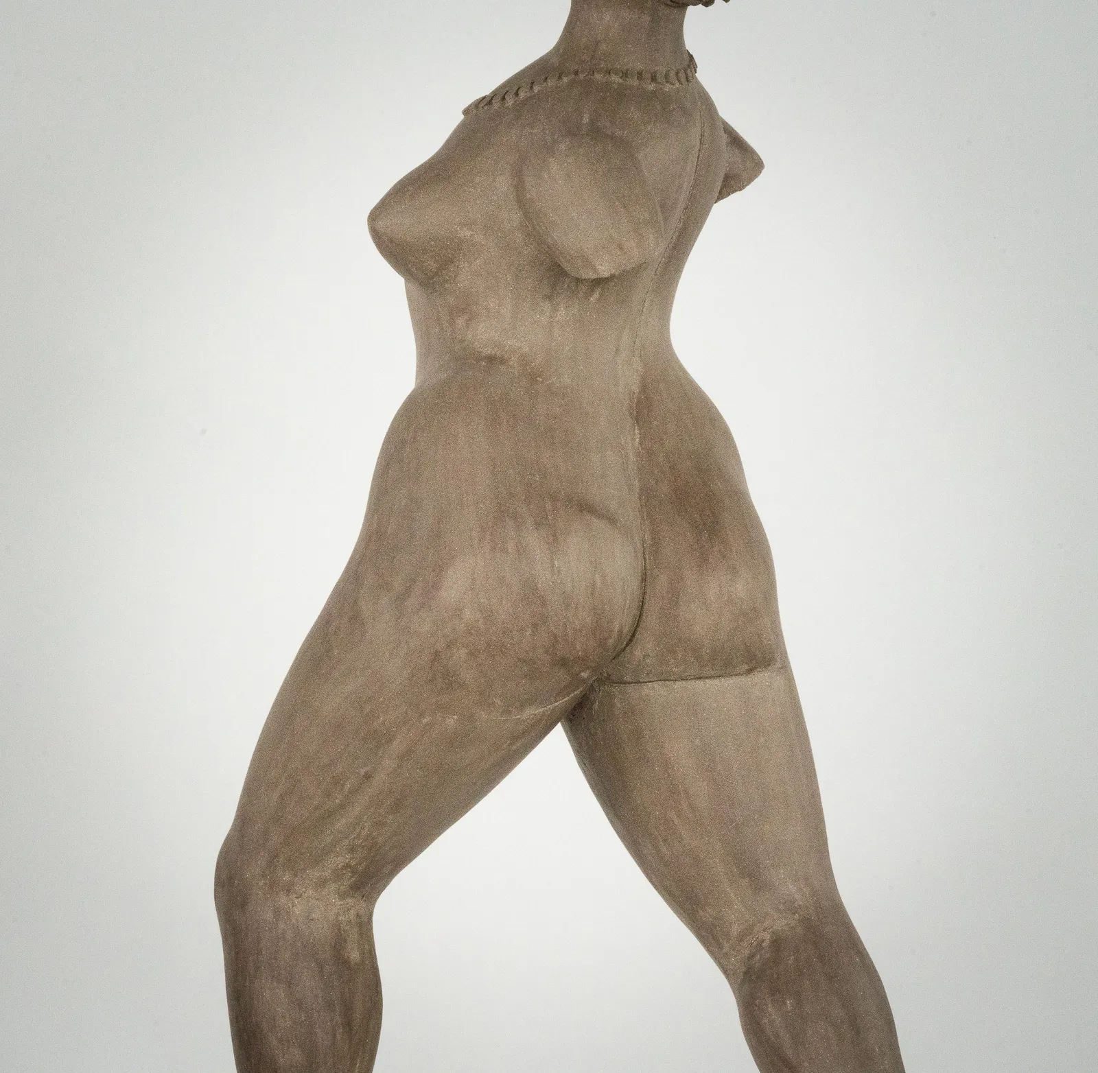 Figurative ceramic sculpture by artist Emilio DiIorio. Female figure is No. 3 in artist's The Dance series in gray clay.