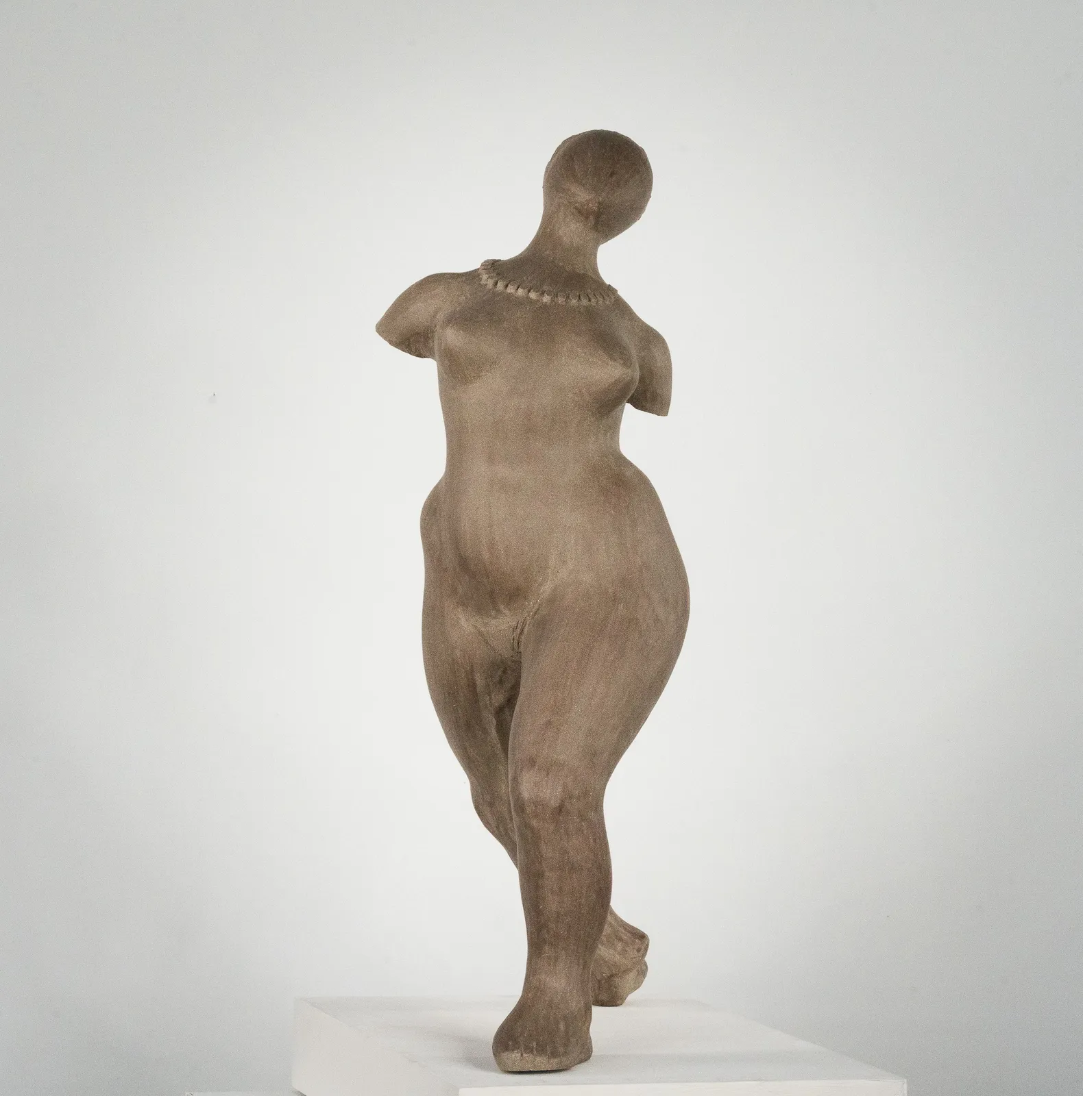 Figurative ceramic sculpture by artist Emilio DiIorio. Female figure is No. 3 in artist's The Dance series in gray clay.