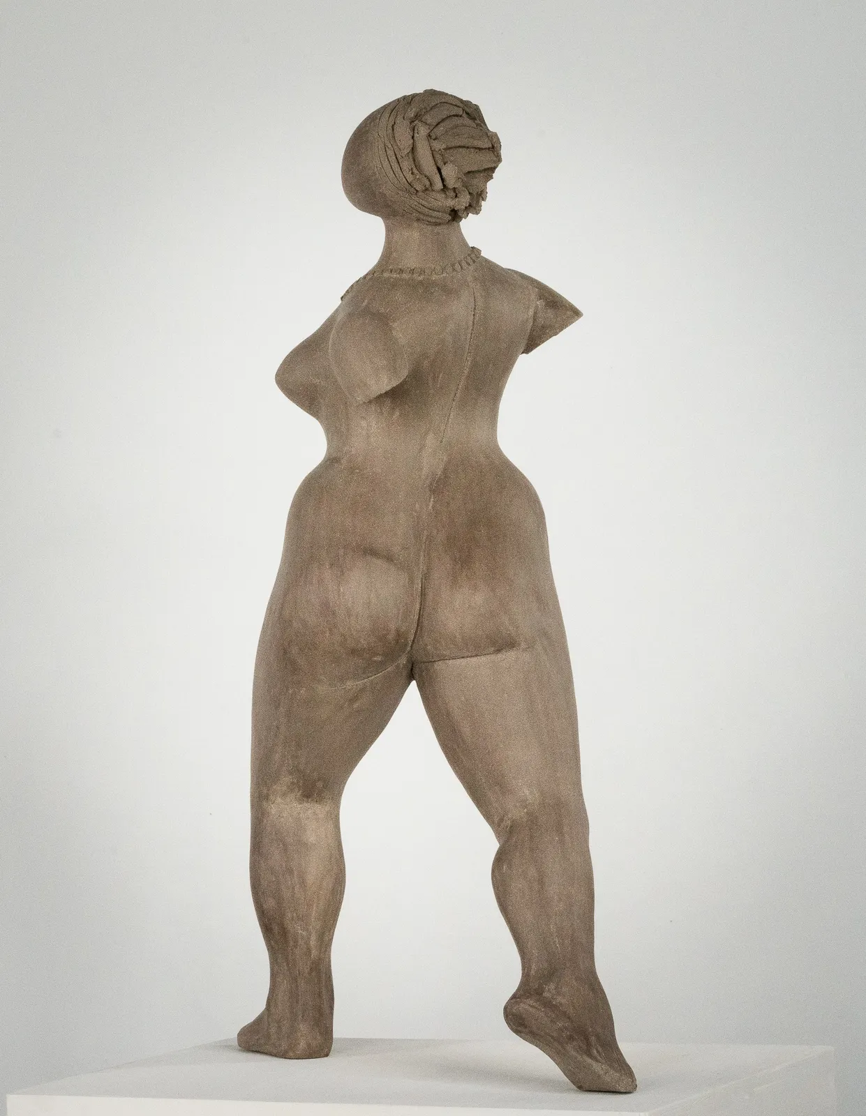 Figurative ceramic sculpture by artist Emilio DiIorio. Female figure is No. 3 in artist's The Dance series in gray clay.