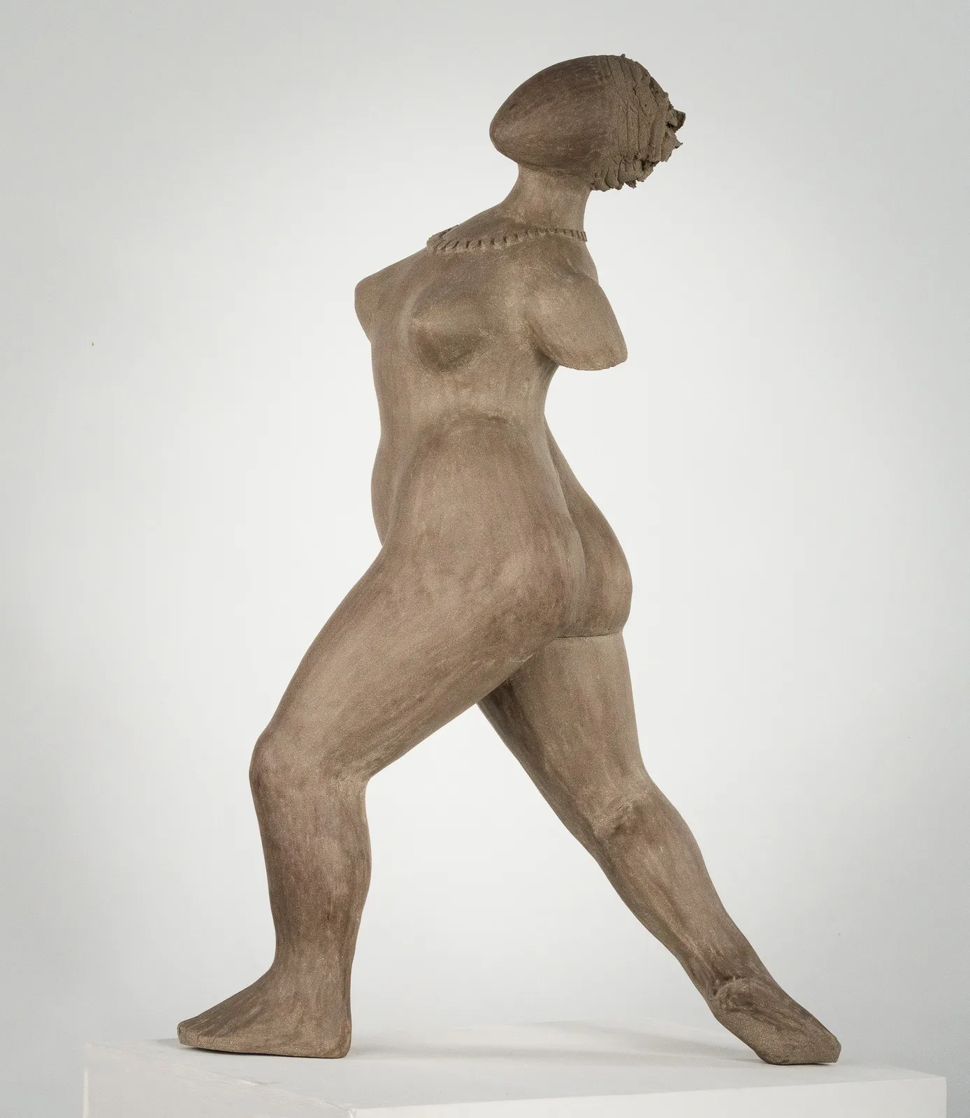 Figurative ceramic sculpture by artist Emilio DiIorio. Female figure is No. 3 in artist's The Dance series in gray clay.