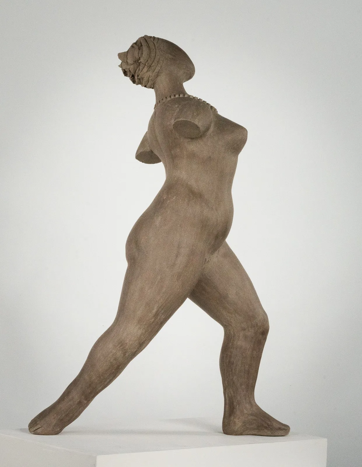Figurative ceramic sculpture by artist Emilio DiIorio. Female figure is No. 3 in artist's The Dance series in gray clay.