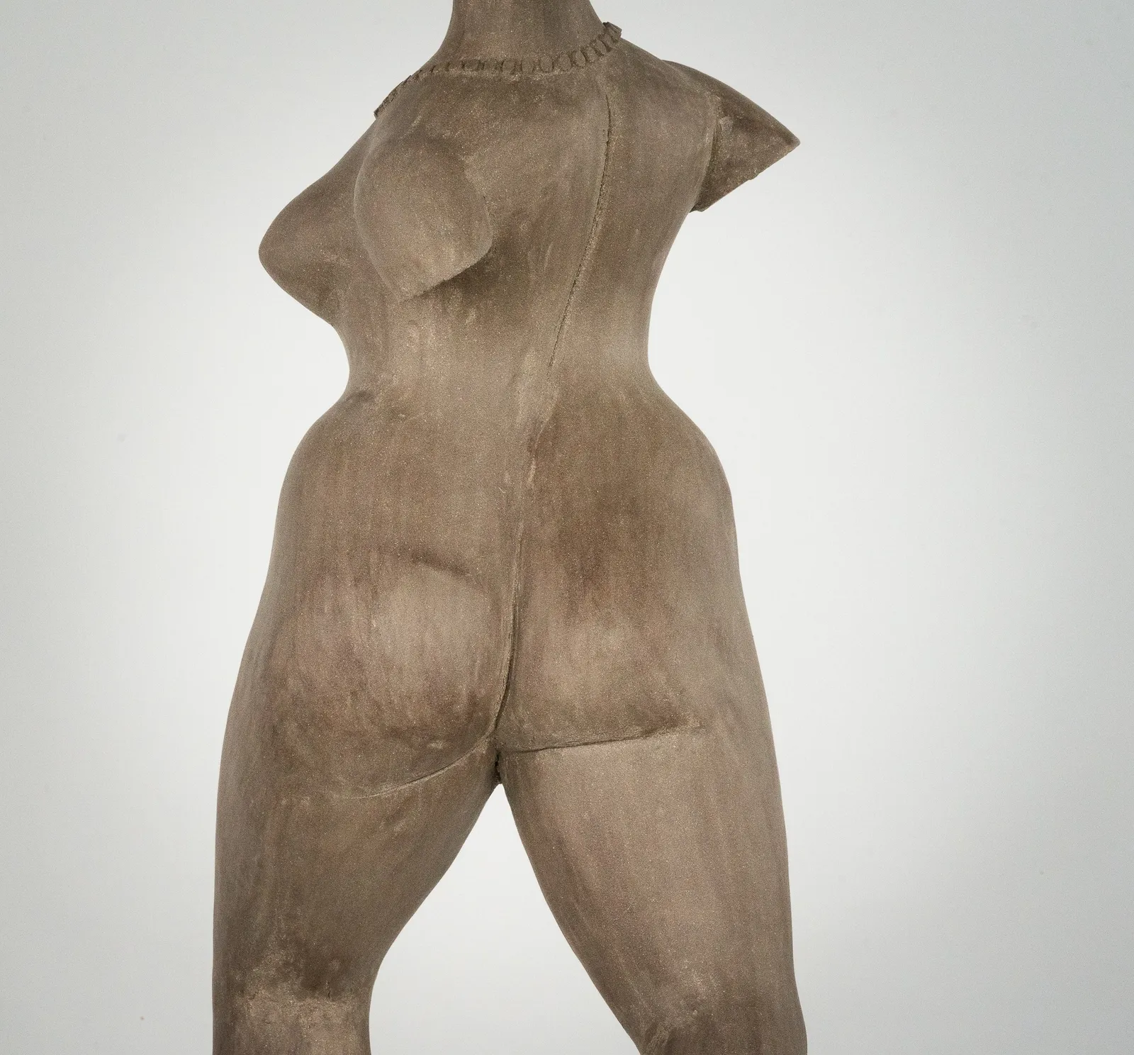Figurative ceramic sculpture by artist Emilio DiIorio. Female figure is No. 3 in artist's The Dance series in gray clay.