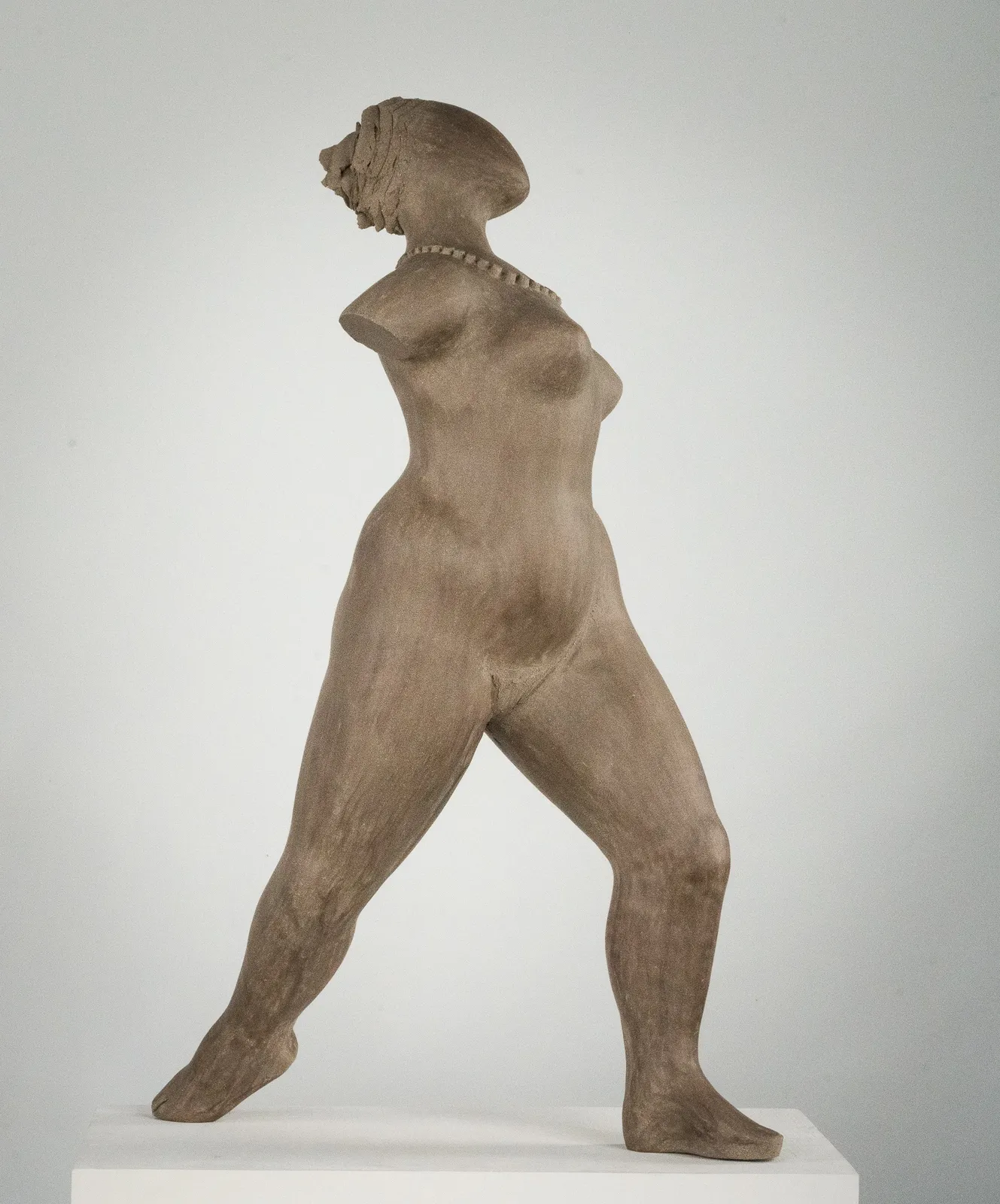 Figurative ceramic sculpture by artist Emilio DiIorio. Female figure is No. 3 in artist's The Dance series in gray clay.