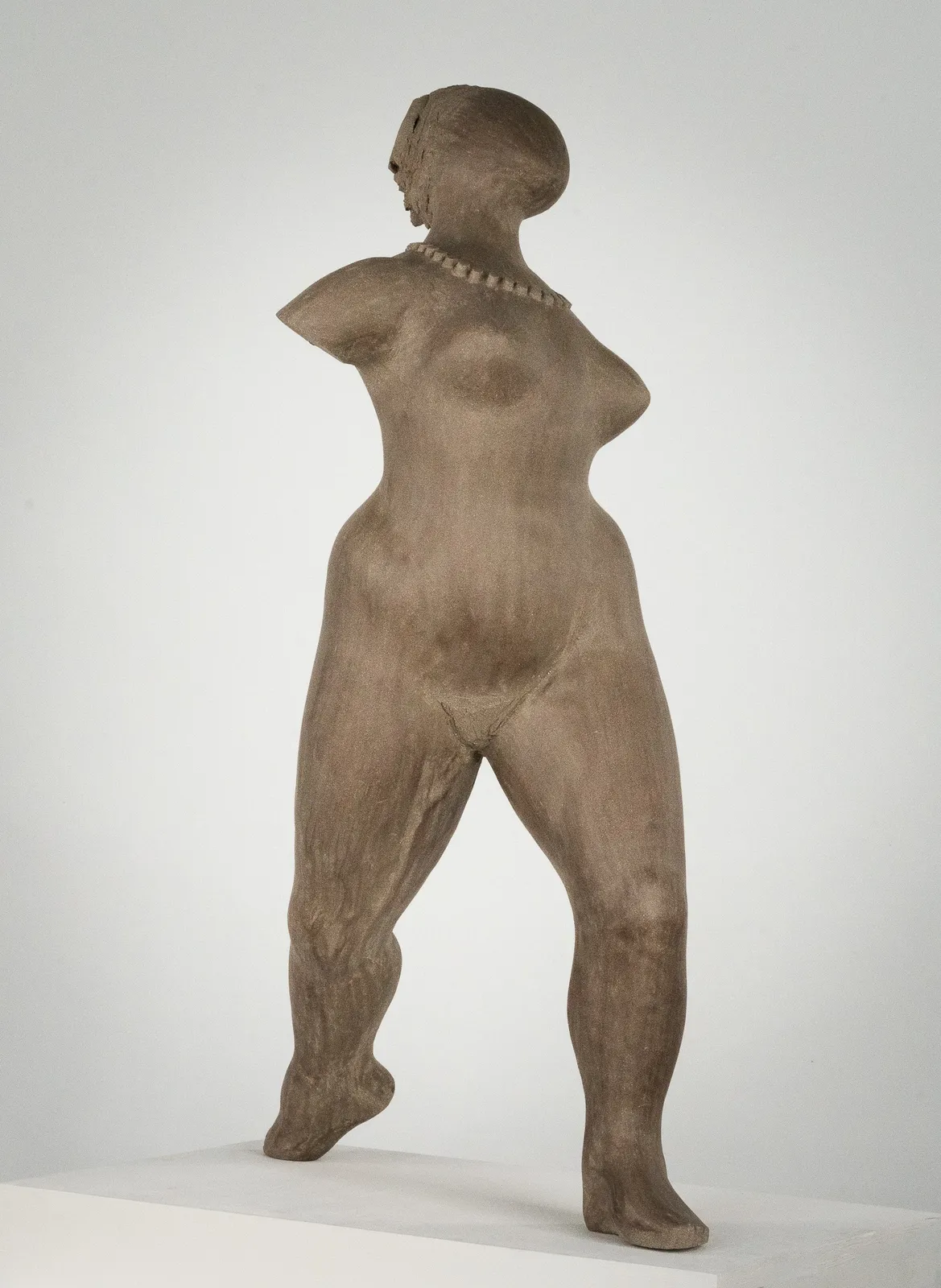 Figurative ceramic sculpture by artist Emilio DiIorio. Female figure is No. 3 in artist's The Dance series in gray clay.