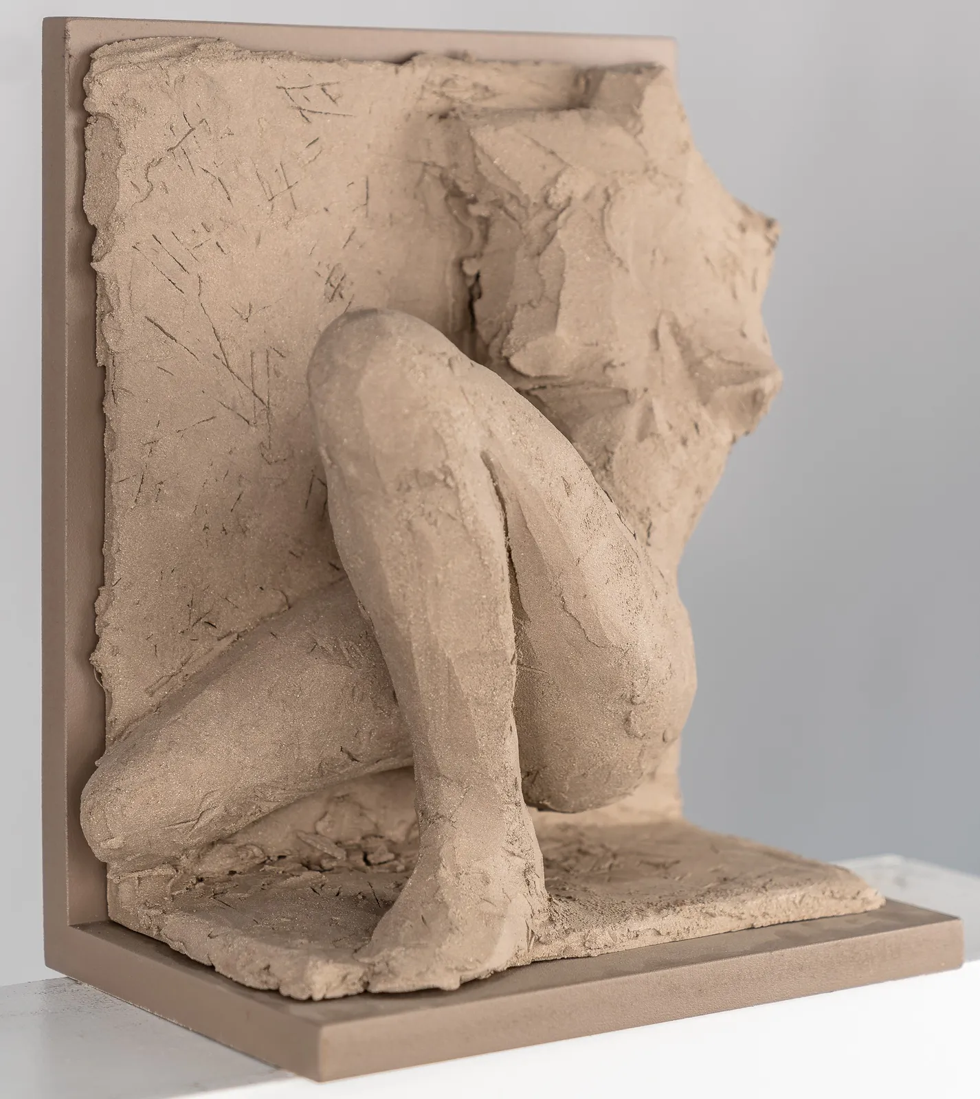 Figurative ceramic relief by artist Emilio DiIorio in Women of Troy series in gray clay.