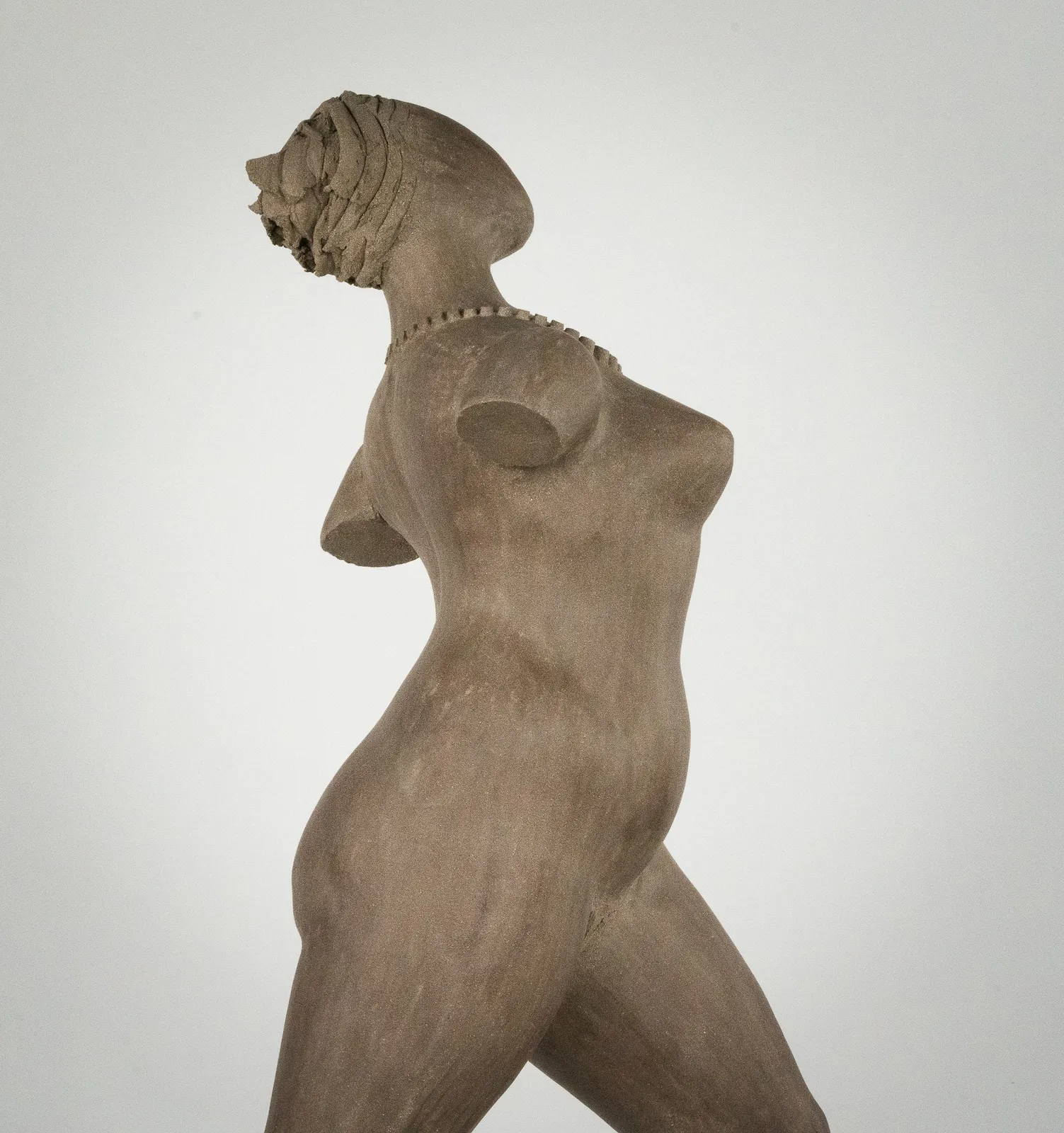 Figurative ceramic sculpture by artist Emilio DiIorio. Female figure is No. 3 in artist's The Dance series in gray clay.