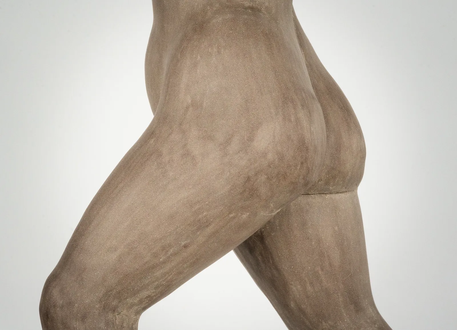 Figurative ceramic sculpture by artist Emilio DiIorio. Female figure is No. 3 in artist's The Dance series in gray clay.