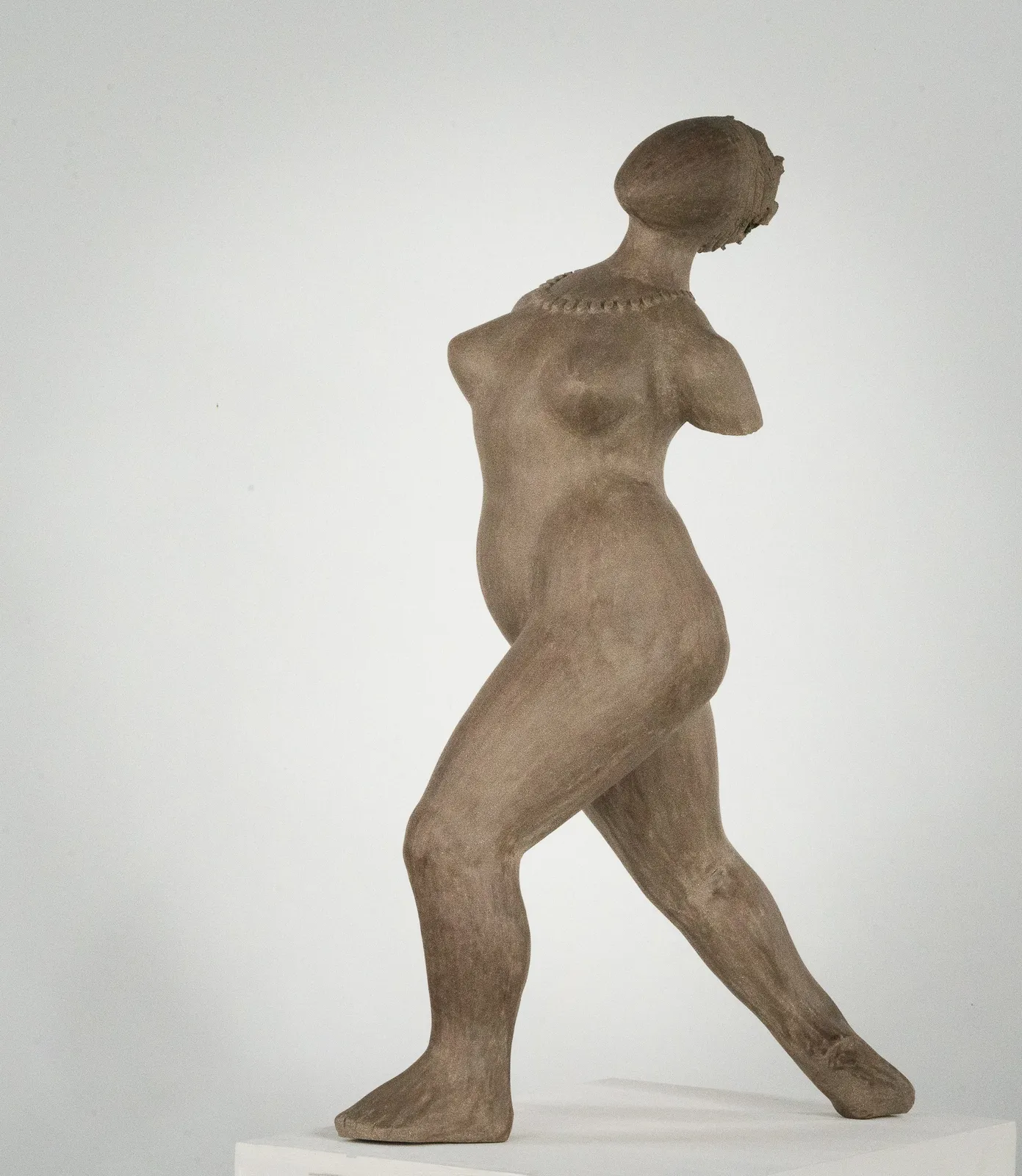 Figurative ceramic sculpture by artist Emilio DiIorio. Female figure is No. 3 in artist's The Dance series in gray clay.