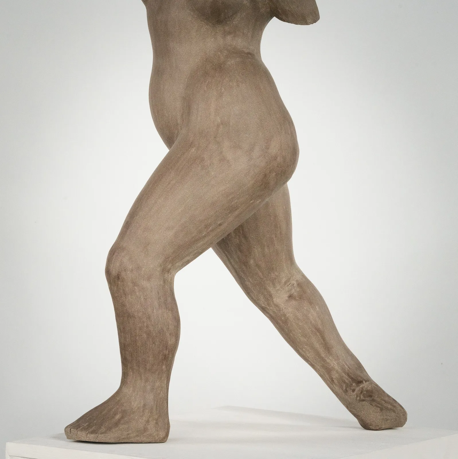 Figurative ceramic sculpture by artist Emilio DiIorio. Female figure is No. 3 in artist's The Dance series in gray clay.